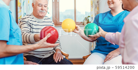 Group of seniors doing sport and gymnastics with balls 59514200