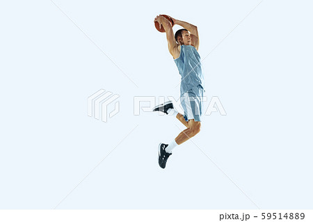 Young caucasian basketball player against white studio background 59514889