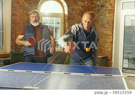 Senior men playing table tennis in workplace, having fun 59515359
