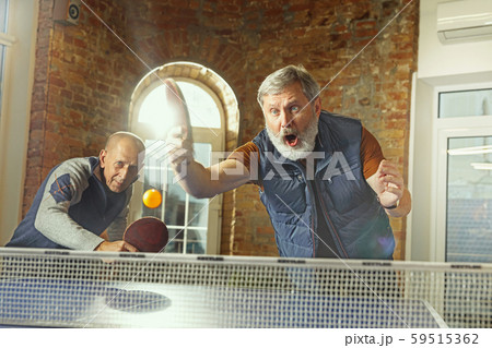 Senior men playing table tennis in workplace, having fun 59515362