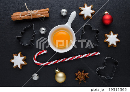ingredients with kitchen tools for dessert baking and star cookies on black background ingredients with kitchen tools for dessert baking and star cookies on black background 59515566