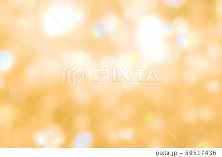Blur yellow gold bokeh background of reflective glittering light from holiday party crystal ball chandelier 59517436