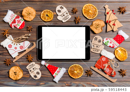 Top view of tablet on holiday wooden background. 59518443