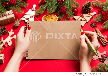 Top view of female hand making some notes in 59518489