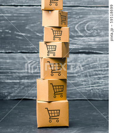 Tower of cardboard boxes with pattern of shopping carts on a blue background. commerce, online shopping. Purchasing power, delivery order. E-commerce, logistics, distribution and sales. Tower of cardboard boxes with pattern of shopping carts on a blue background. commerce, online shopping. Purchasing power, delivery order. E-commerce, logistics, distribution and sales. 59518699
