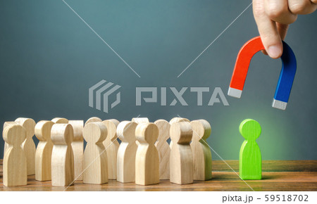 A hand with a magnet is trying to pull a green figure of a person out of a crowd. Recruiting new workers. Formation of a new business team. Search for talented workers with great career potentia. A hand with a magnet is trying to pull a green figure of a person out of a crowd. Recruiting new workers. Formation of a new business team. Search for talented workers with great career potentia. 59518702