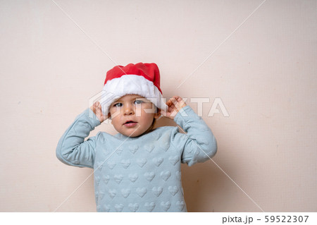 Funny little kid in red hat Santa. Christmas concept. Dancing happily. Funny little kid in red hat Santa. Christmas concept. Dancing happily. 59522307