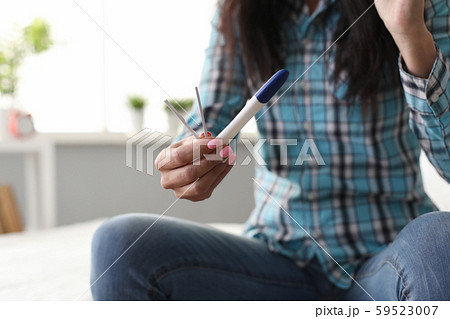 Person with pregnancy test Person with pregnancy test 59523007