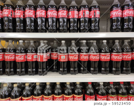 COKE-COLA drinks in large bottles are displayed on a shelf for sale in a large supermarket. Placed in large quantities based on high demand. COKE-COLA drinks in large bottles are displayed on a shelf for sale in a large supermarket. Placed in large quantities based on high demand. 59523450