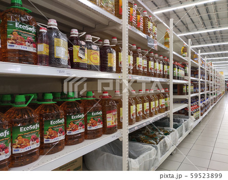 Cooking oil made from processed palm oil displayed for sale inside the supermarket. Sorted by the brand to make easy for the customer to choose.  59523899
