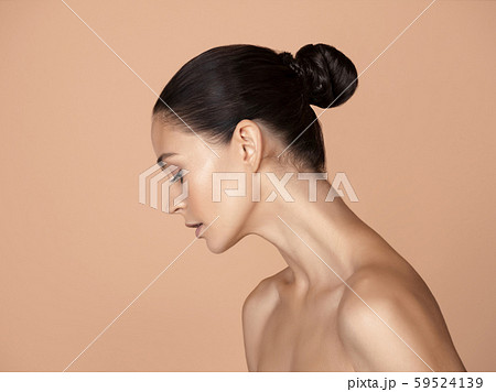 Portrait of beautiful young woman isolated on brown studio background Portrait of beautiful young woman isolated on brown studio background 59524139