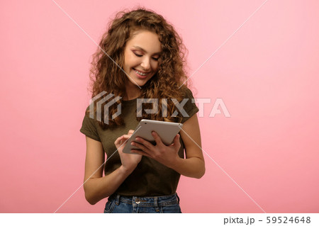 Pretty girl with tablet on pink background 59524648