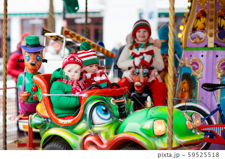 Kids at Christmas fair. Child at Xmas market. 59525518