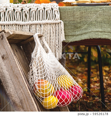 White string bag with apple and pomegranates as a White string bag with apple and pomegranates as a 59526178