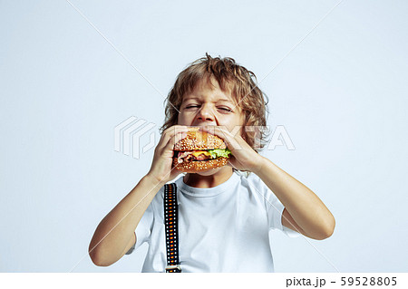 Pretty young boy in casual clothes on white studio background Pretty young boy in casual clothes on white studio background 59528805