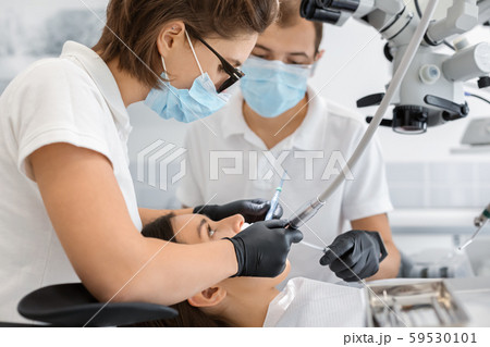 Young woman client attending modern dentist clinic Young woman client attending modern dentist clinic 59530101