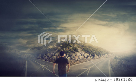Rear view man walking in front of crossroad as 59531536