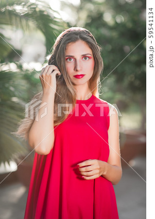 Fashion portrait of a beautiful woman in red dress 59541134