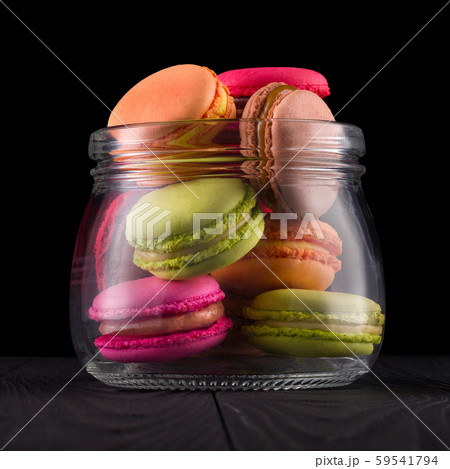 Jar of french colorful macaroon or macaron on wooden table isolated on black Jar of french colorful macaroon or macaron on wooden table isolated on black 59541794