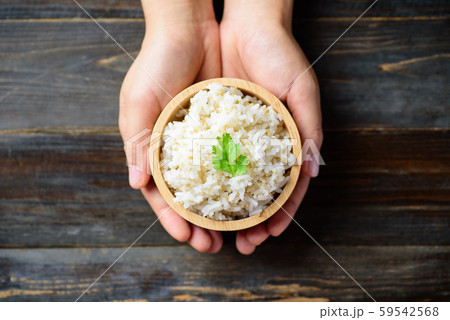 Cooked rice with quinoa seed in bowl holding by hand 59542568
