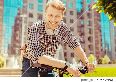 Joyful blonde male person looking straight at camera Joyful blonde male person looking straight at camera 59542998