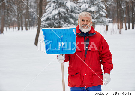 Elderly cleaner posing with shovel outdoors Elderly cleaner posing with shovel outdoors 59544648