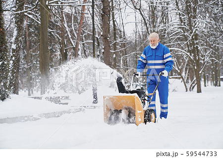 Man cleaning snow with snowblover. 59544733