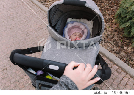 First person view of mother strolling with newborn outside. Mother's hands First person view of mother strolling with newborn outside. Mother's hands 59546665