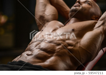 Handsome strong athletic men pumping up muscles 59547211