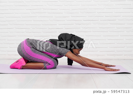 Young muslim woman stretching back while doing yoga 59547313