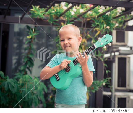 Portrait of a cute boy with ukulele Portrait of a cute boy with ukulele 59547362