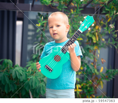 Portrait of a cute boy with ukulele Portrait of a cute boy with ukulele 59547363