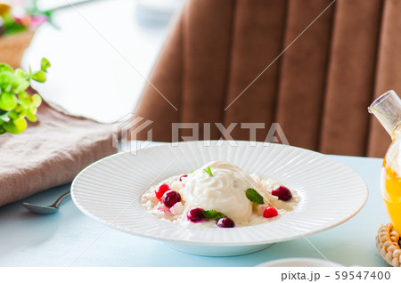 Rice porridge with milk and cranberry in a plate 59547400