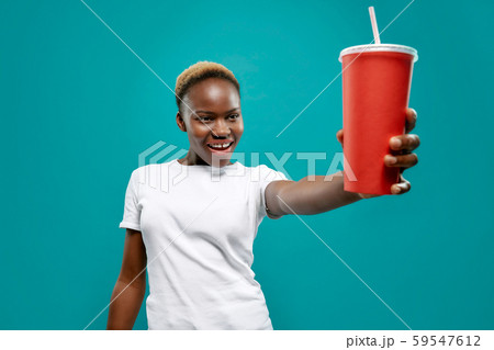 Selective focus of cold drink in hand of african female 59547612