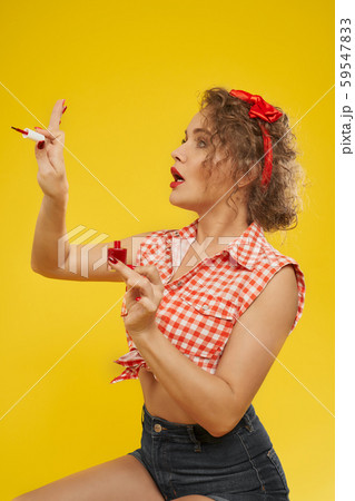 Stylish girl looks satisfied with new selfmade manicure Stylish girl looks satisfied with new selfmade manicure 59547833
