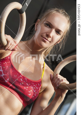 Portrait of Sporty woman showing well trained abdominal muscles Portrait of Sporty woman showing well trained abdominal muscles 59548453