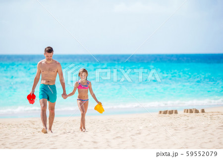 Little girl and happy dad playing on the beach Little girl and happy dad playing on the beach 59552079