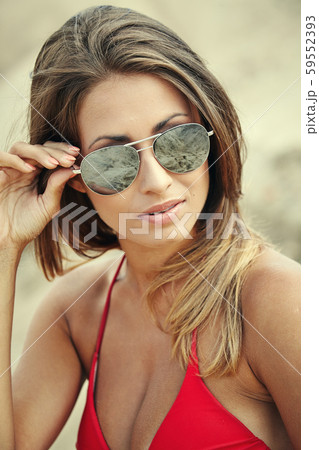 Young beautiful woman in red bikini and sunglasses 59552393