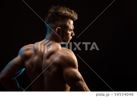 Strong Athletic Fitness Man posing back muscles, triceps, latissimus over black background 59554046