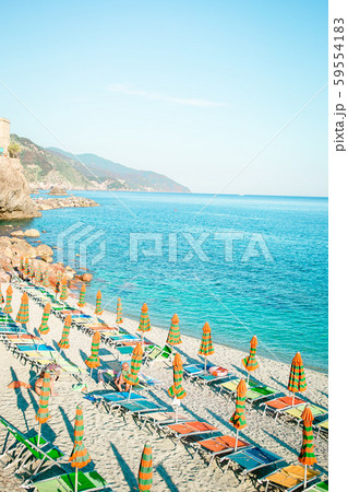 Sunbeds and umbrellas at beautiful european seashore in Monterosso in Italy, Cinque Terre, Liguria Sunbeds and umbrellas at beautiful european seashore in Monterosso in Italy, Cinque Terre, Liguria 59554183