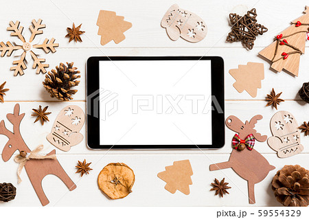 Top view of tablet on holiday wooden background. 59554329