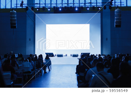Audience at the conference hall. focus on the scene. People are waiting for the speaker. blue tinted Audience at the conference hall. focus on the scene. People are waiting for the speaker. blue tinted 59556549