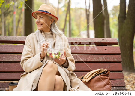 Cheerful stylish business lady having lunch outdoors 59560648