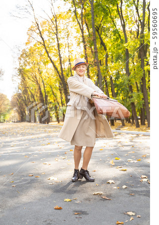 Caucasian woman with a bag standing outdoors 59560695