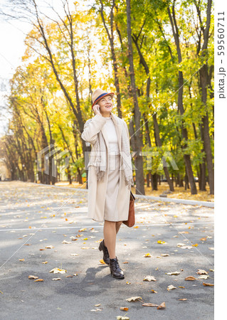 Joyous business lady using her phone outside 59560711