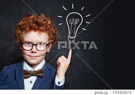 Successful child boy showing lightbulb. Successful child boy showing lightbulb. 59560874