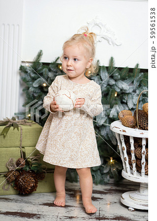 Cute little girl with blonde hair decorating 59561538