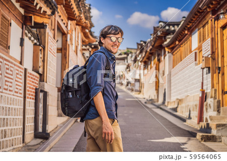 Young man tourist in Bukchon Hanok Village is one of the famous place for Korean traditional houses 59564065