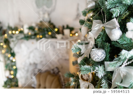 Closeup of Christmas tree branches with decorative balls, ribbon bows, snowflakes, pine cones and 59564515