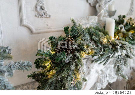 Closeup of Christmas tree branches with decorative balls, ribbon bows, snowflakes, pine cones and 59564522